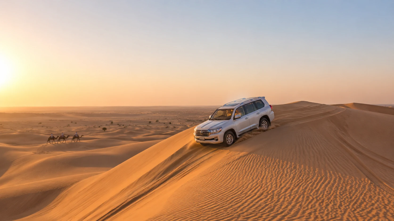 Luxury 4x4 dune bashing across Dubai desert at sunset